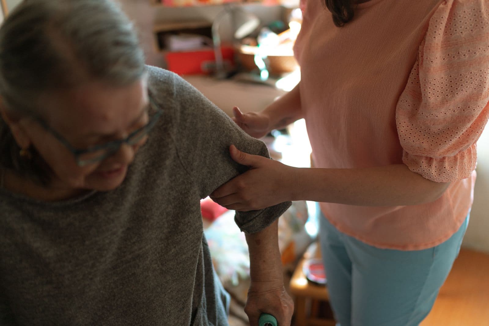 A carer supporting an older woman safely at home